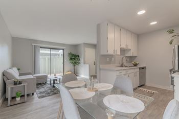 a living room and kitchen with a table and chairs at The Gates at The Marina Apartments, Marina
